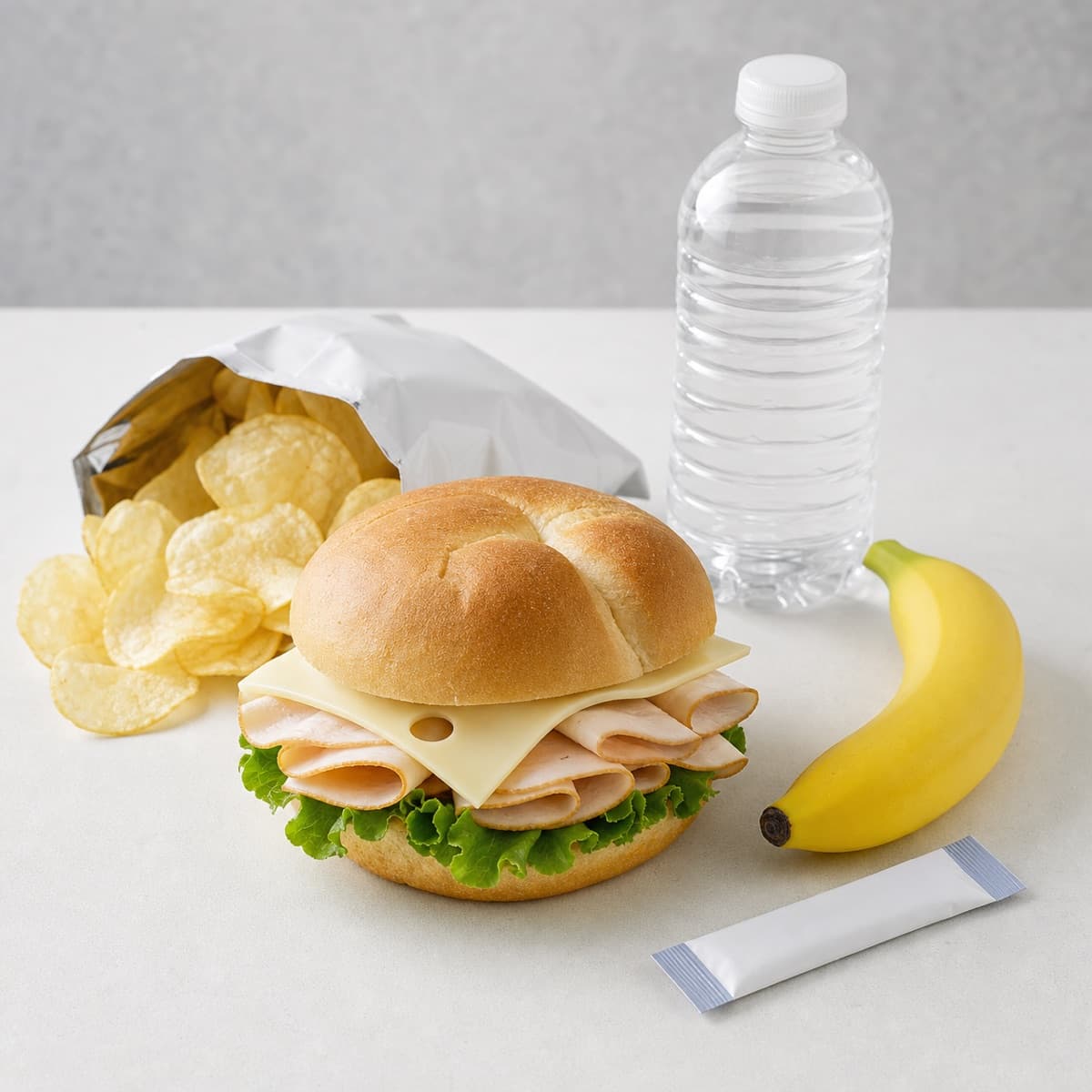 Turkey sandwich, chips, water, and electrolyte packet